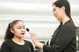 two students doing makeup